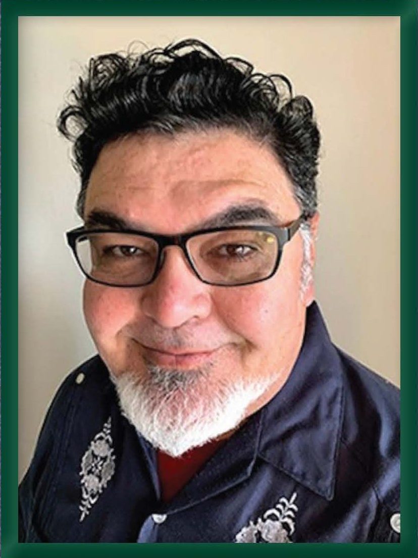 Jaime Cortez headshot goateed man in glasses in navy guayabera