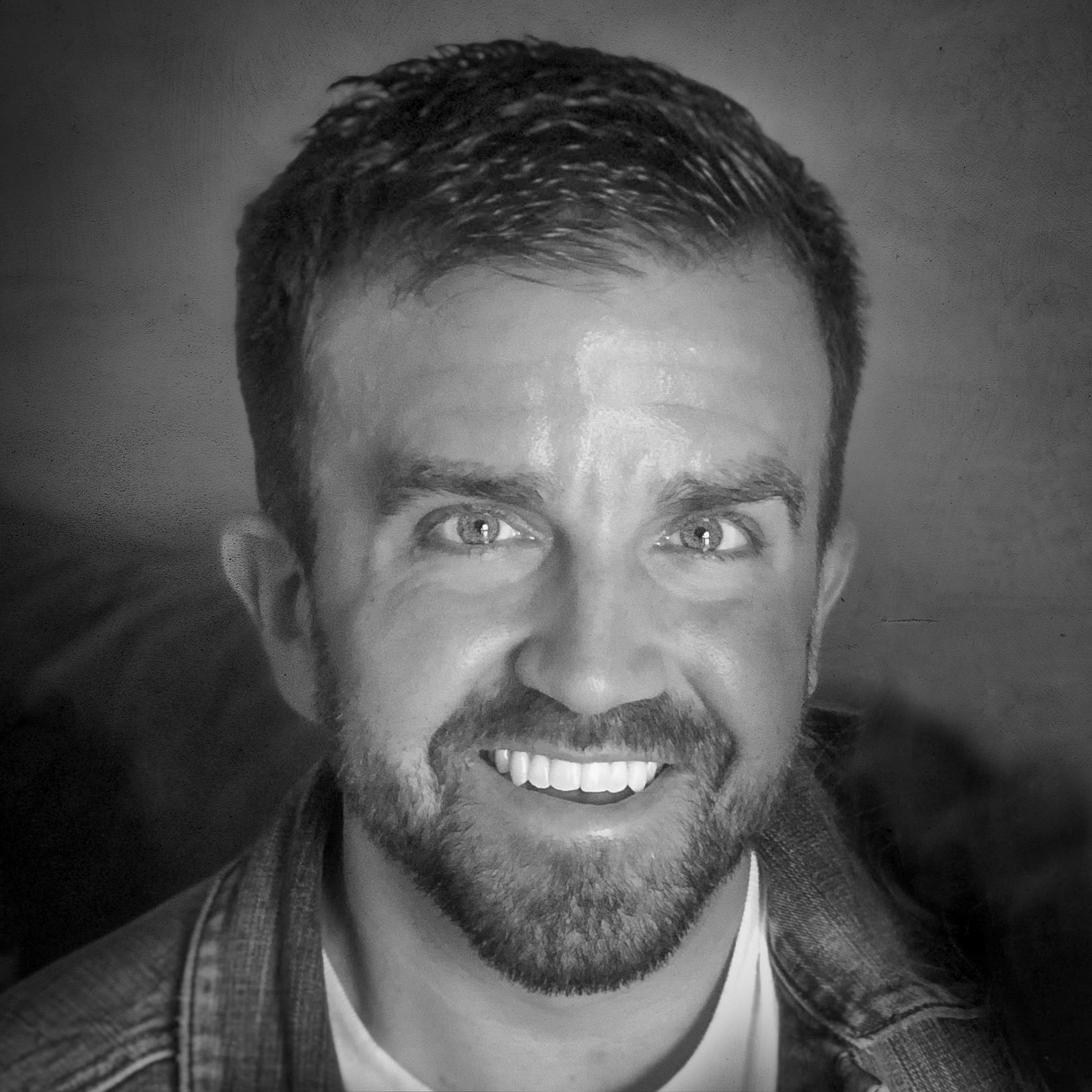 B &W headshot of G. W. Currier, brown hair, short beard, wide smile