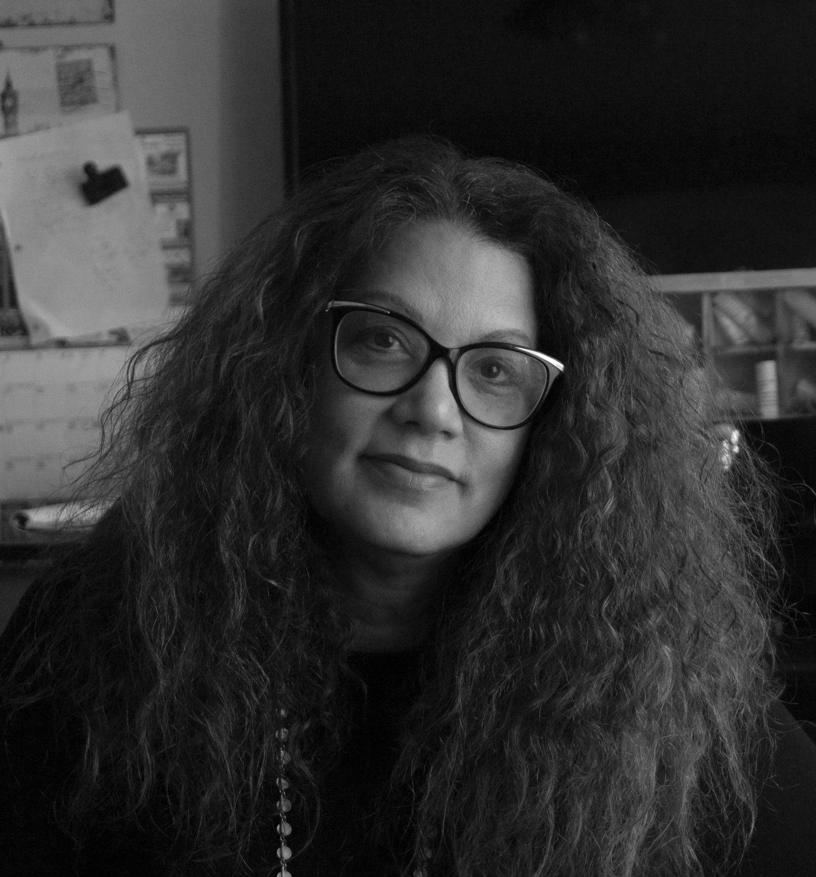 B&W Author photo of Robin Lee Lovelace: headshot of woman with thick, long, wavy dark hair, glasses.